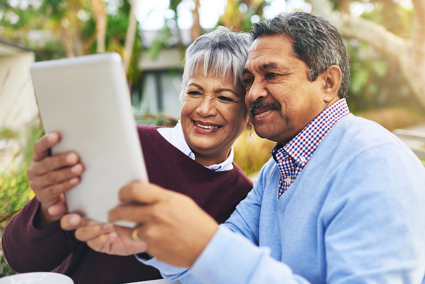 Shot of an older couple using a digital tablet together outdoors
